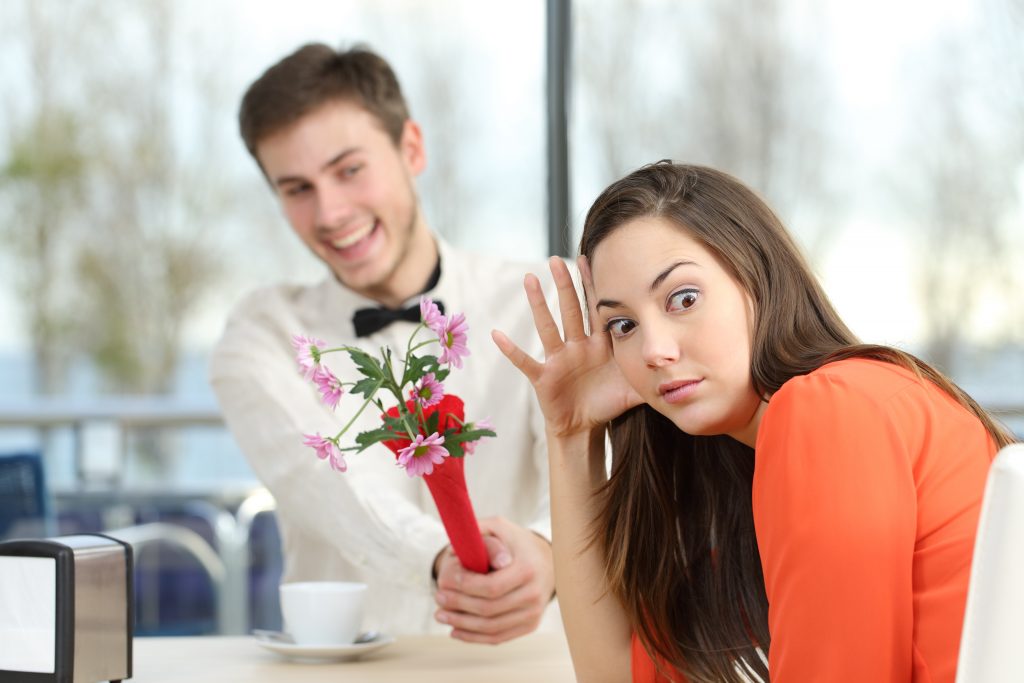 Disgusted Woman Rejecting A Geek Boy with Flowers