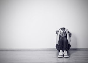 Girl Sits In A Depression On The Floor