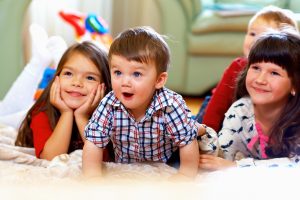 Group Of Happy Kids Watching TV