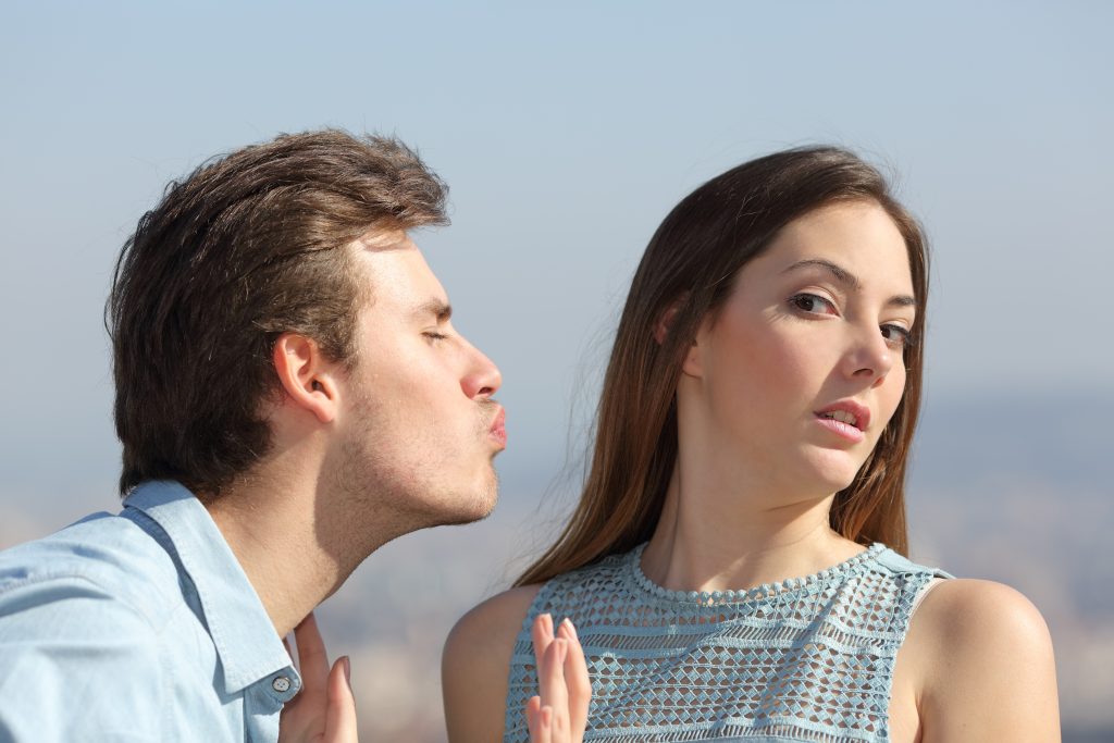 Man Trying To Kiss A Woman And She Rejecting Him