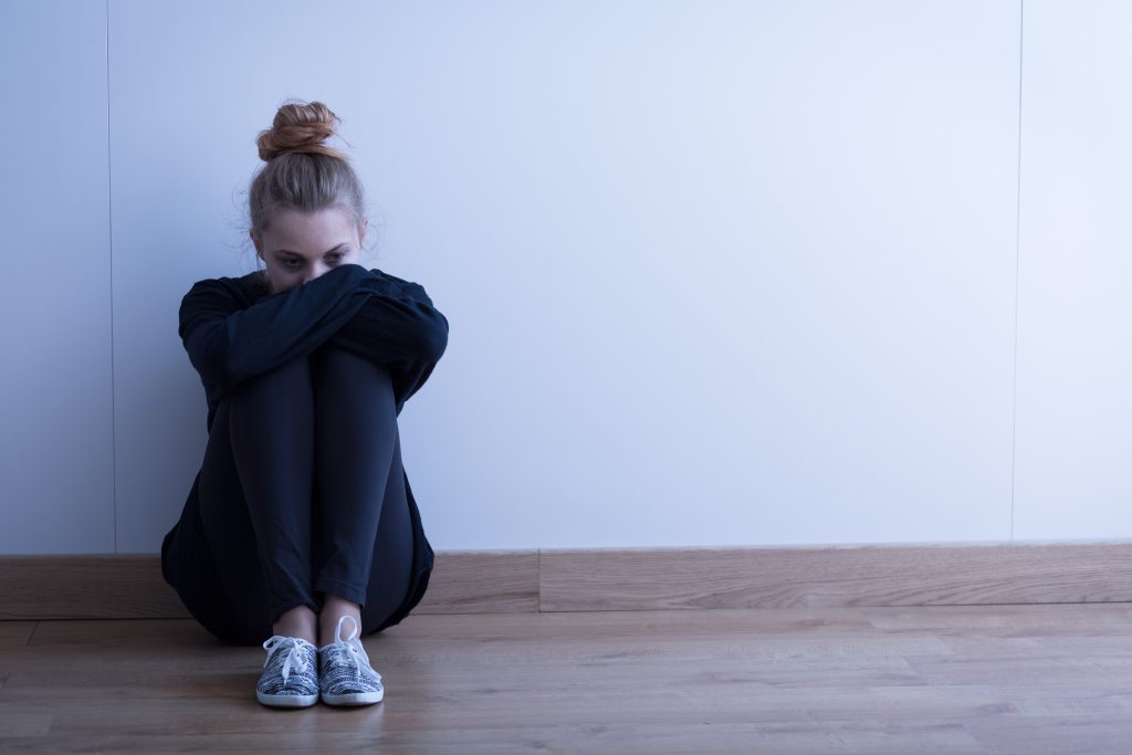 Sad Woman With Depression Sitting On The Floor