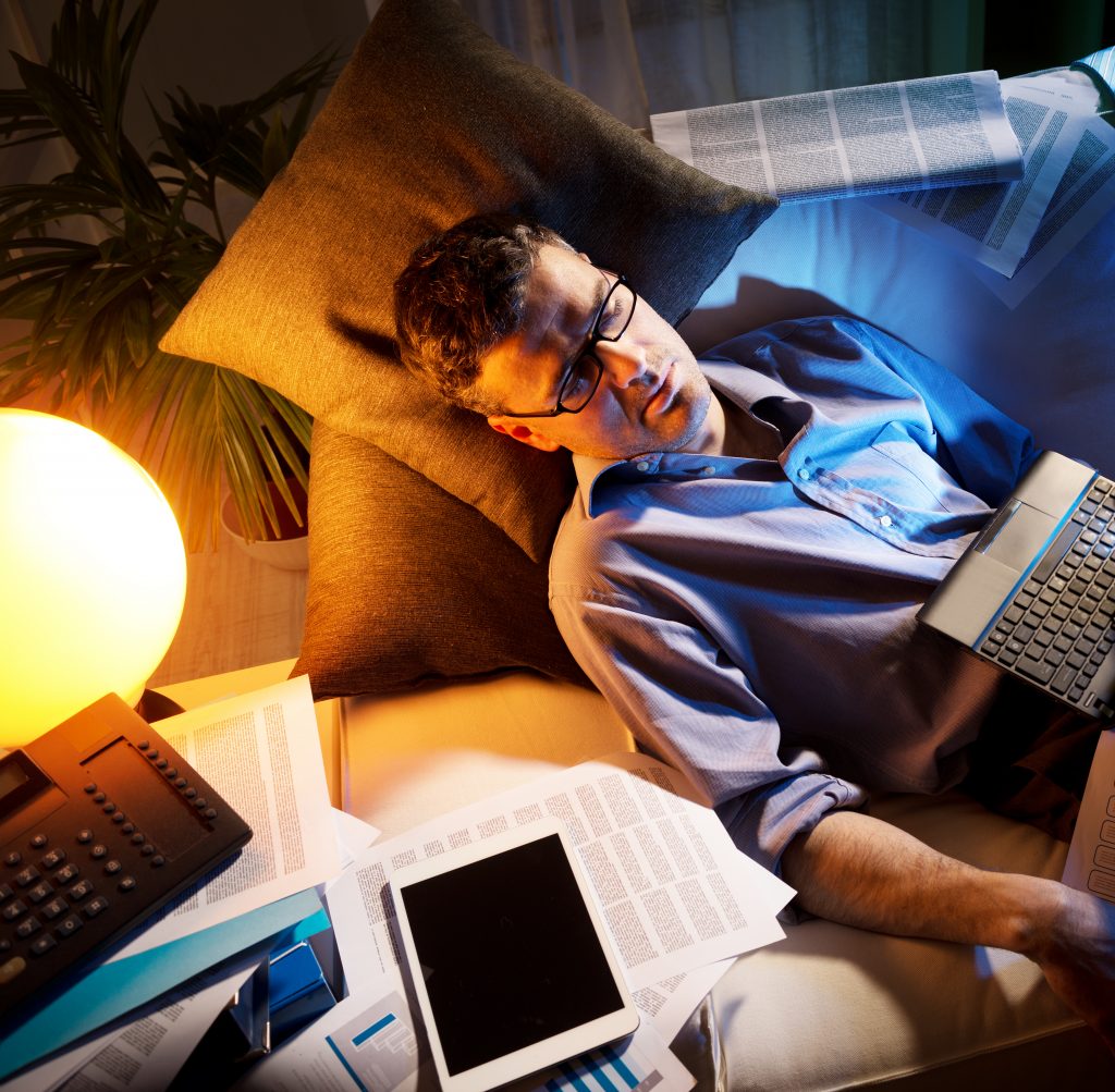 Tired Businessman Sleeping On Sofa